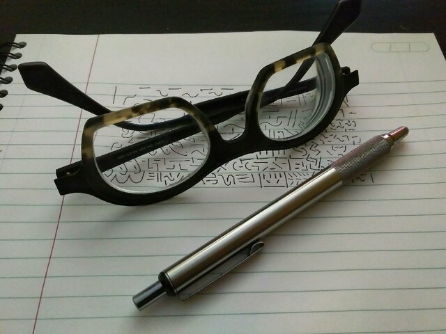Pen, Paper, Glasses and Drawing
